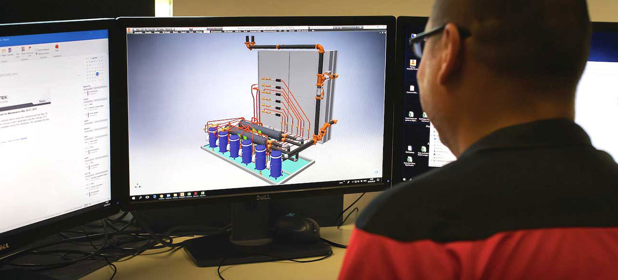 Man creating 3D model on computer screen