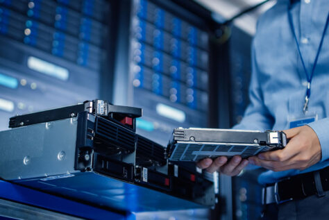 IT Engineer Installing Hardware Equipment into Server Rack